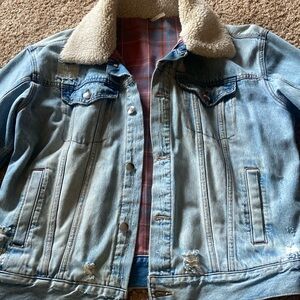Lightly distressed trucker-style Free People jacket with pink plaid lining